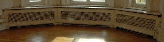 Appraisal: Three single panelled cast radiator surrounds with marble tops on