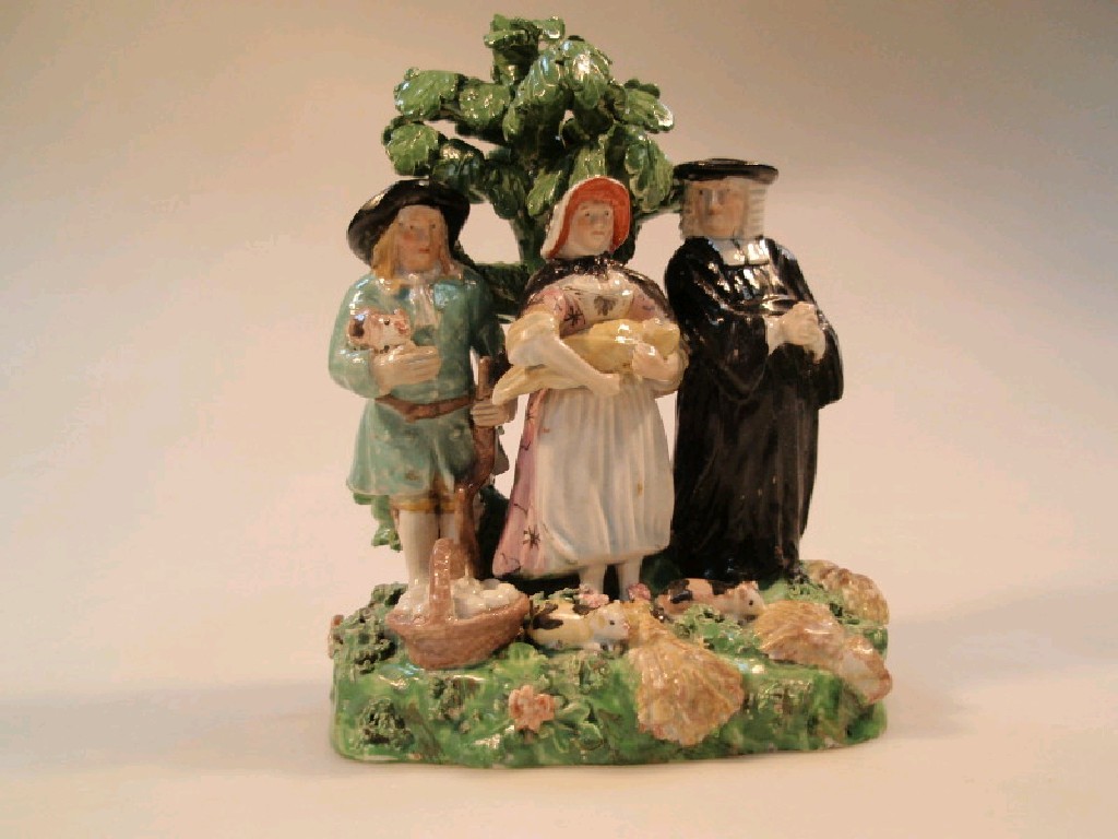 Appraisal: A Staffordshire pearlware Tithe pig group with three figures before