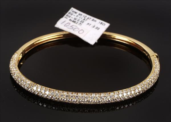 Appraisal: A diamond hinged bangle by Dianoor the top pave set