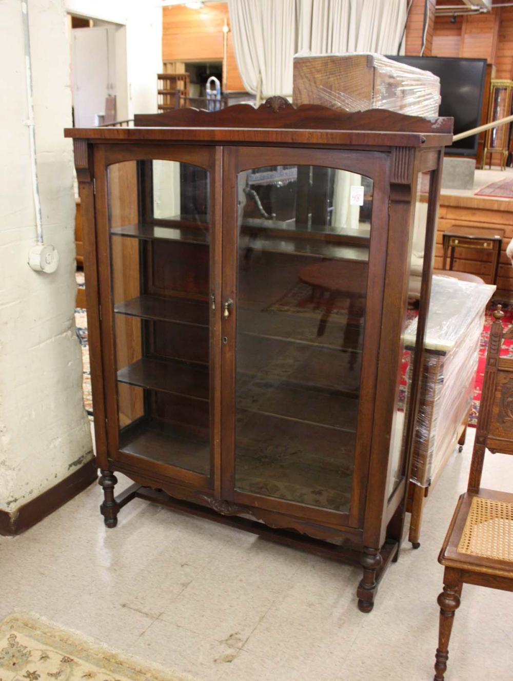 Appraisal: WALNUT DOUBLE-DOOR CHINA CABINET American c 's having three interior