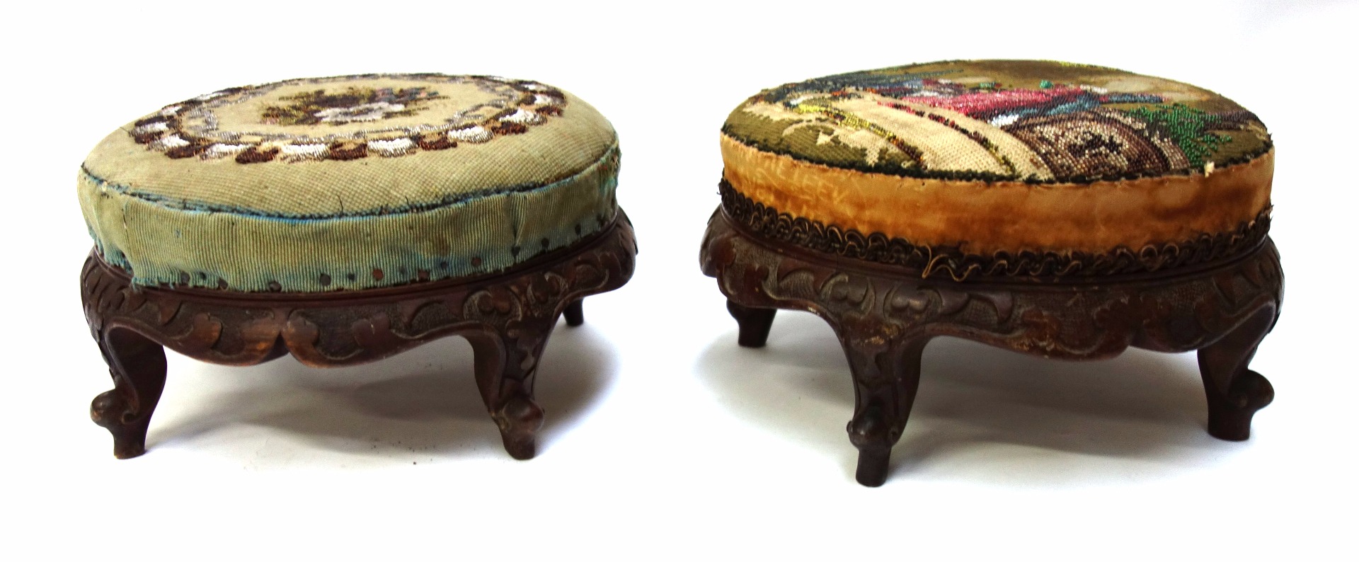 Appraisal: A pair of Victorian circular footstools on carved walnut bases