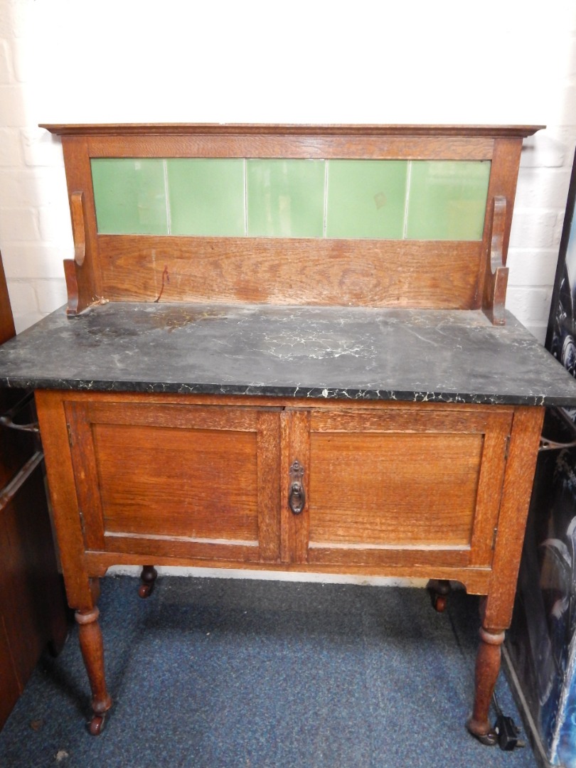 Appraisal: A Victorian oak and black marble topped wash stand with