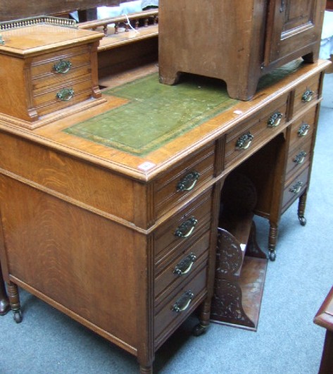 Appraisal: A late Victorian oak pedestal desk the superstructure with central