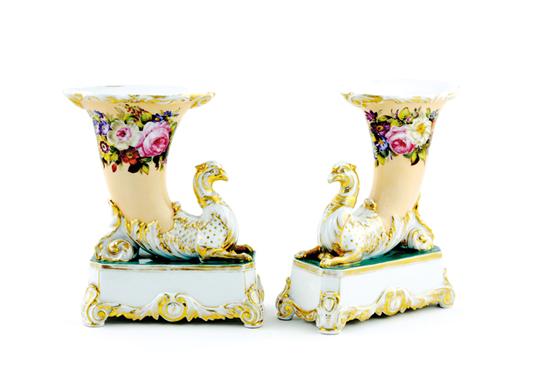 Appraisal: Pair Continental porcelain vases cornucopia supporting mythical birds and molded