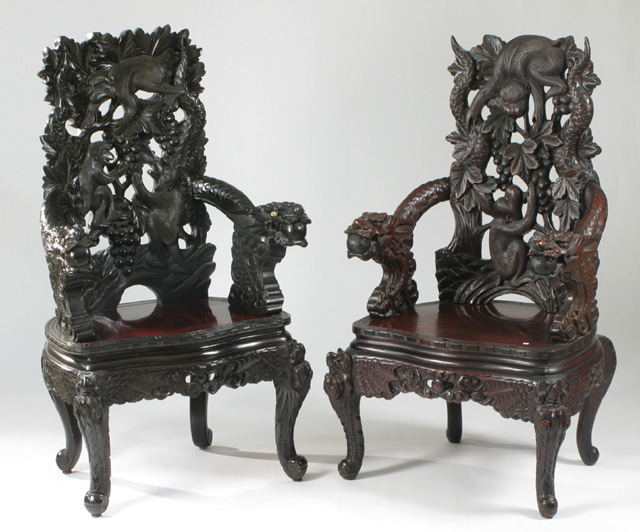 Appraisal: TWO HIGHLY CARVED MANDARIN TEAKWOOD ARMCHAIRS Chinese early th century