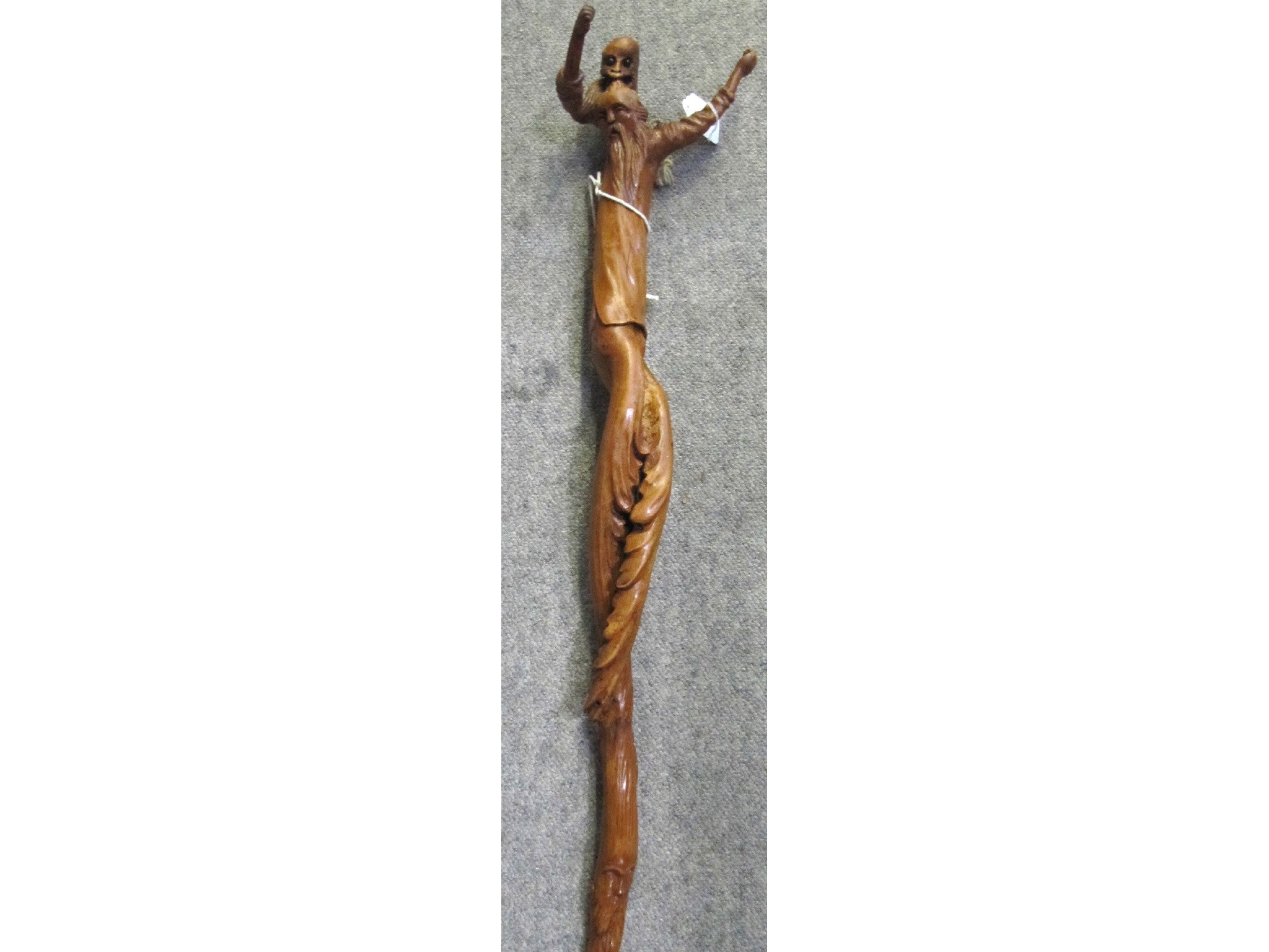 Appraisal: A rootwood walking stick the handle modelled as a haunted