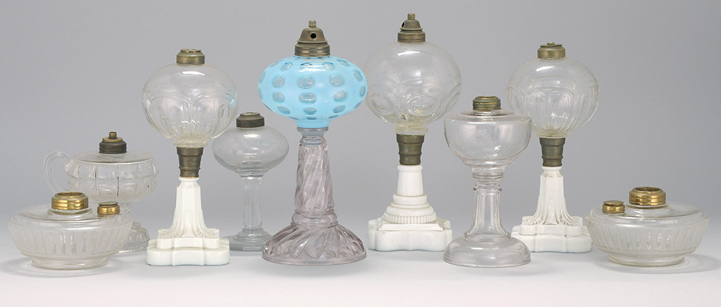 Appraisal: NINE CLEAR AND COLORED GLASS FLUID LAMPS th Early th