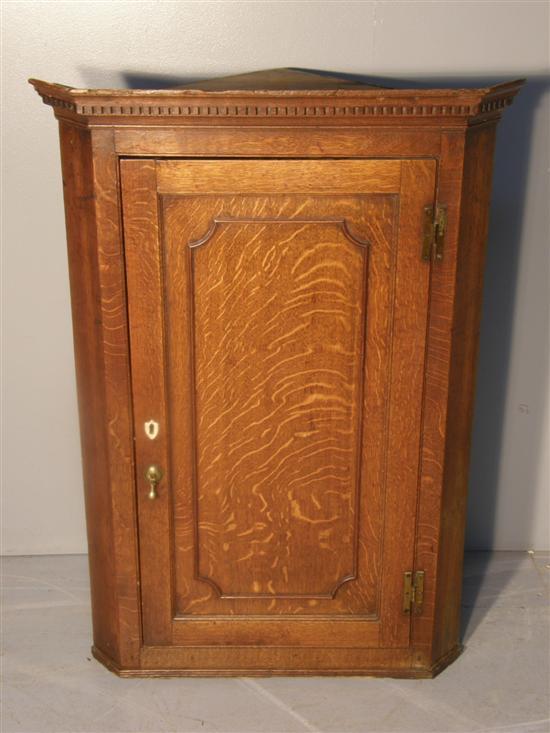 Appraisal: th century oak corner cupboard with dentil cornice panelled door