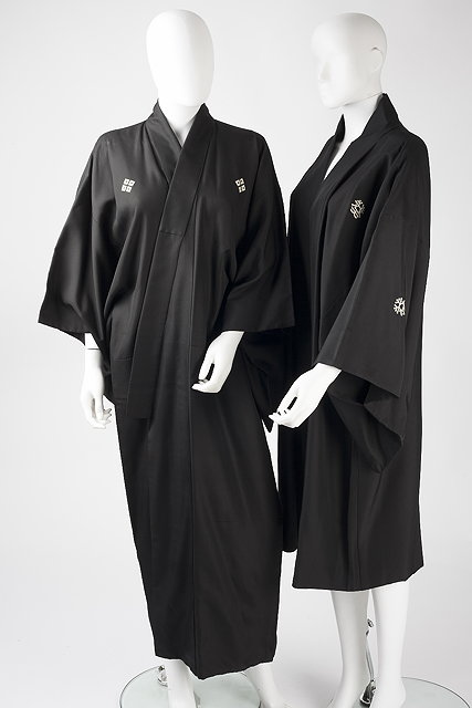 Appraisal: Three black robes the first with cream floral motifs the