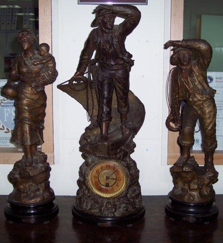 Appraisal: A spelter figural clock garniture the central figure 'Rescue' cm