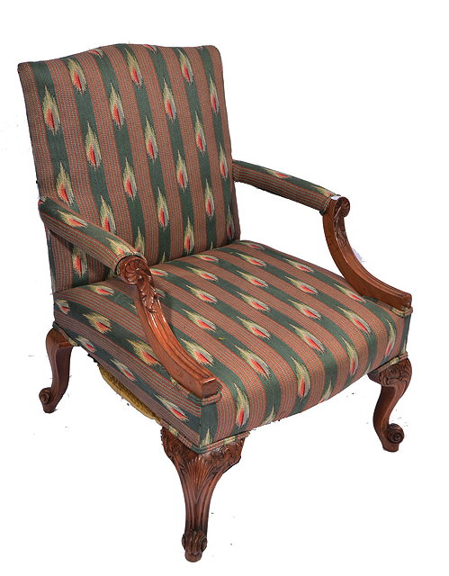 Appraisal: AN TH CENTURY STYLE LIBRARY ARMCHAIR with carved walnut scrolling