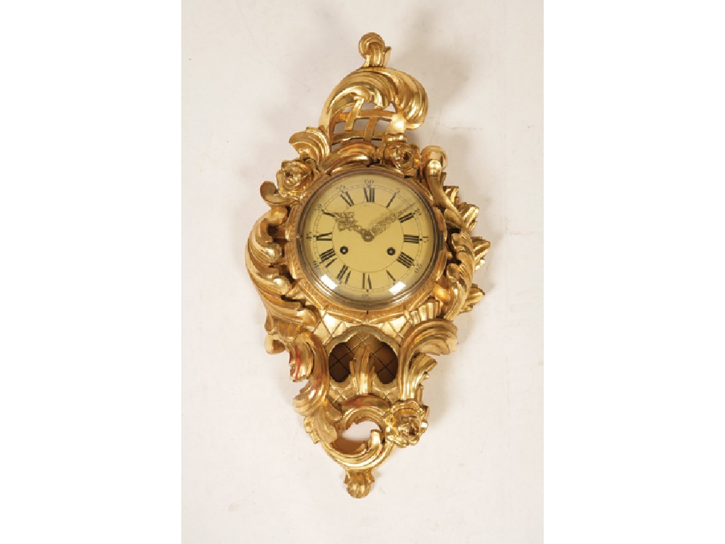 Appraisal: A ROCOCO STYLE FRENCH GILTWOOD WALL CLOCK the scrolling leaf-carved