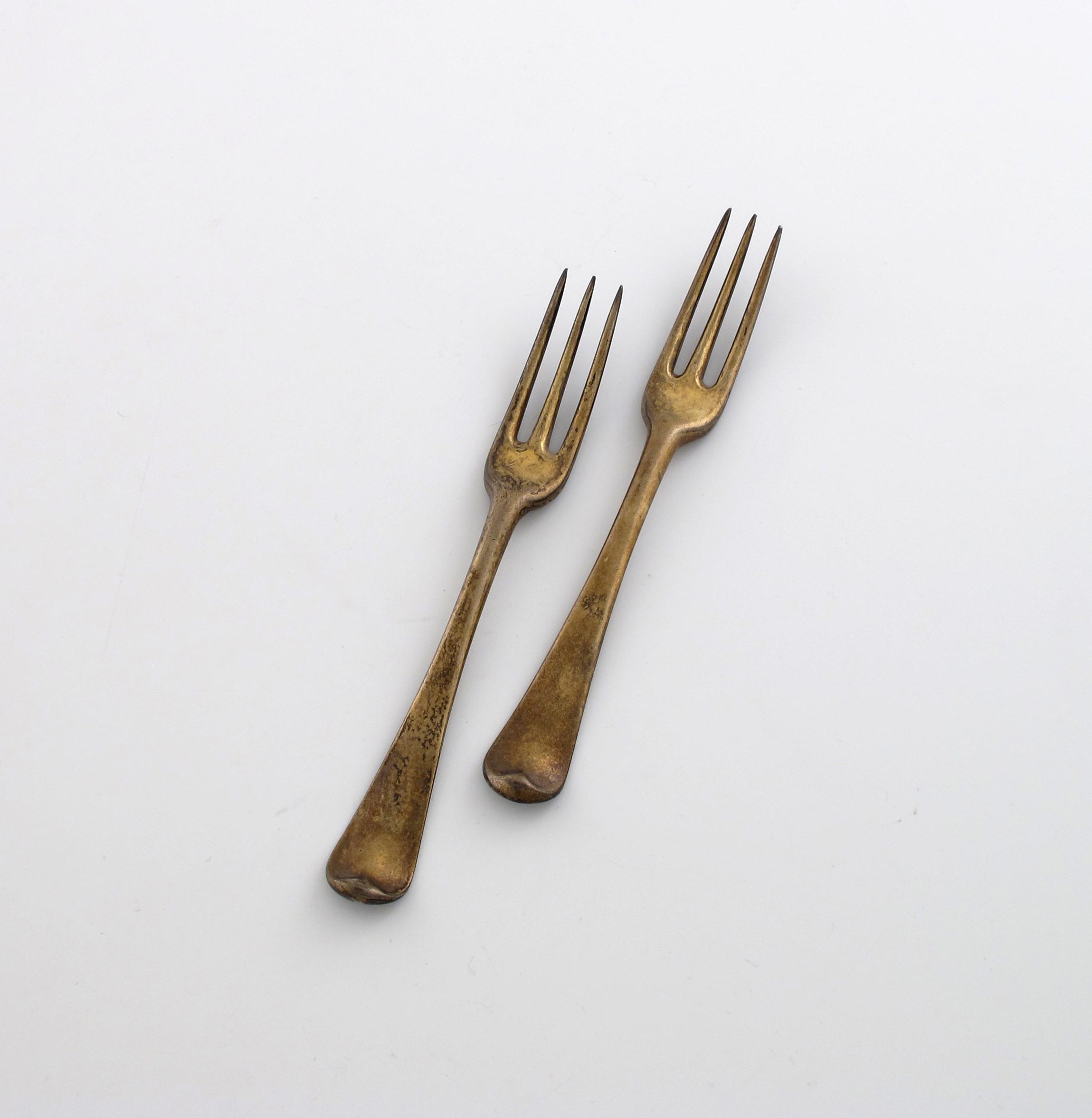 Appraisal: Two George III silver-gilt Hanoverian pattern dessert forks