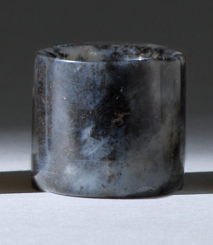 Appraisal: MOTTLED GRAY JADE ARCHER'S RING th CenturyIn cylinder form with