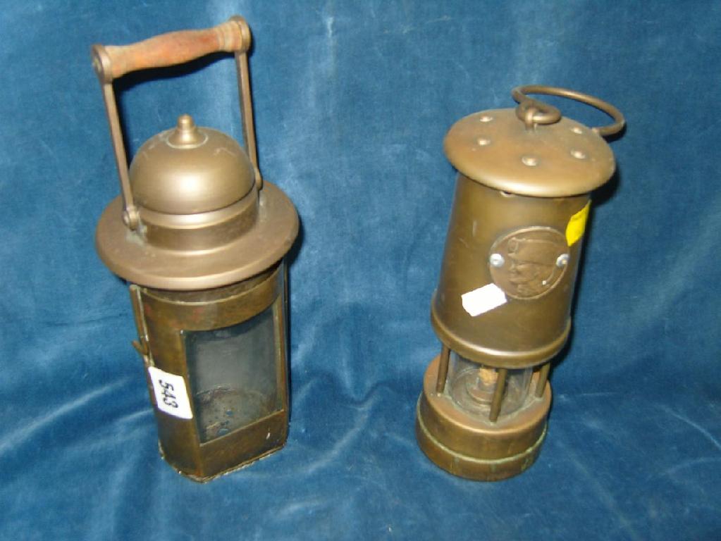 Appraisal: Two brass miners lamps including example with turned wooden handle