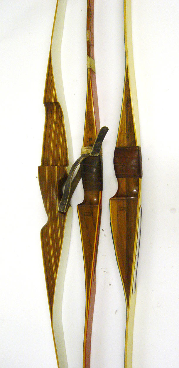 Appraisal: Three carved wooden archers bows one with leather grip by