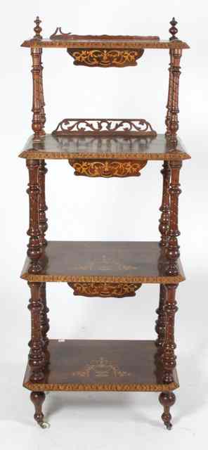 Appraisal: A Victorian walnut four-tier whatnot inlaid urns and foliate scrolls