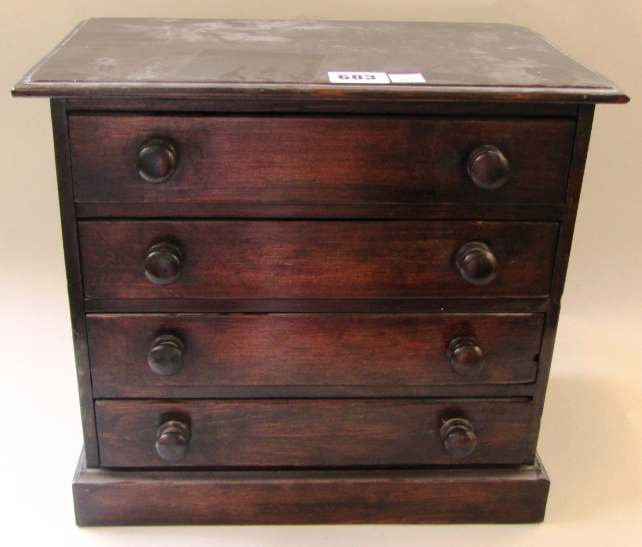 Appraisal: A th century stained beech miniature chest of four long