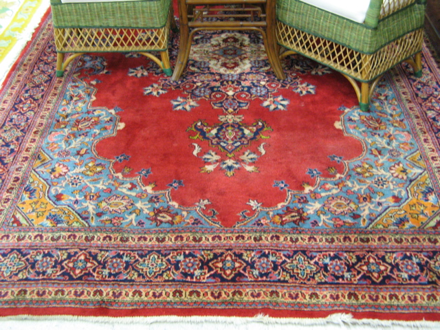 Appraisal: PERSIAN SAROUK CARPET centering a large floral medallion on plain