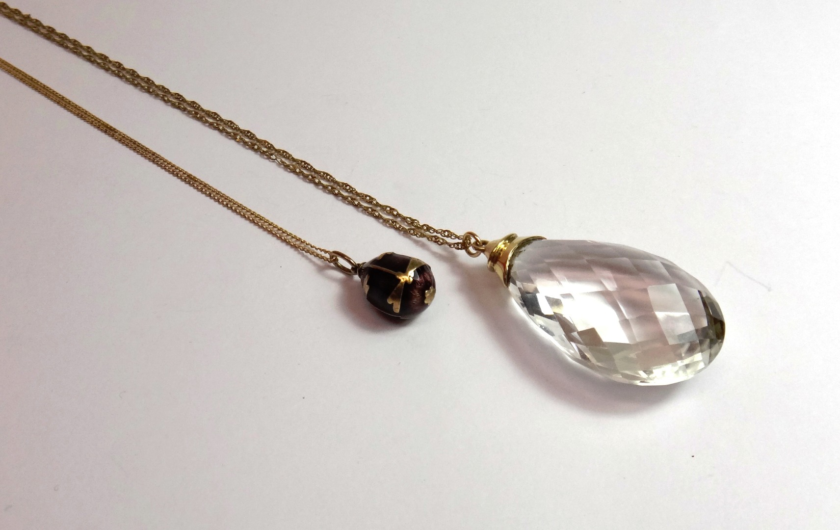 Appraisal: A faceted rock crystal drop shaped pendant with a ct