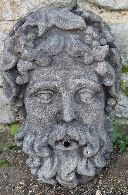 Appraisal: A RECONSTITUTED STONE WALL MOUNTED FOUNTAIN MASK in the form