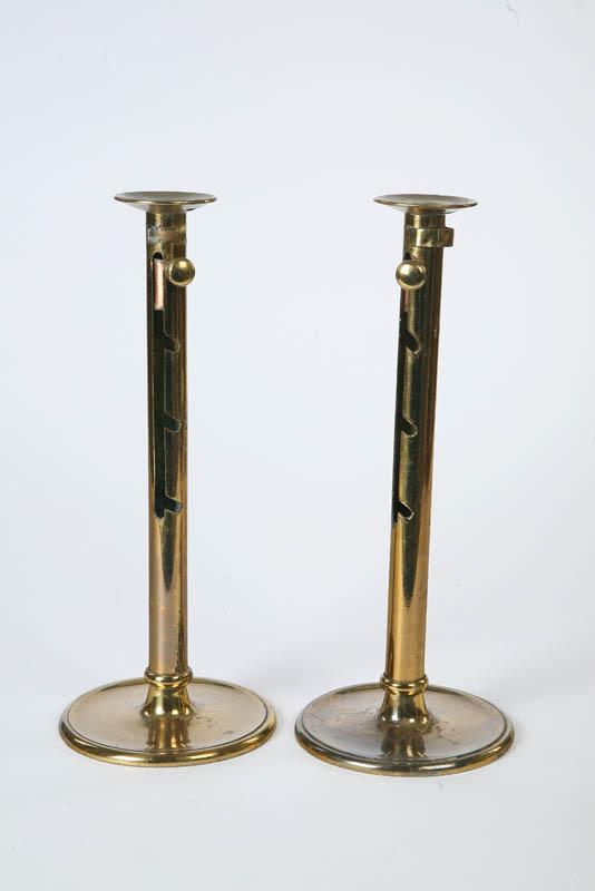 Appraisal: PAIR OF BRASS CANDLESTICKS Large cylindrical sticks with drip pans