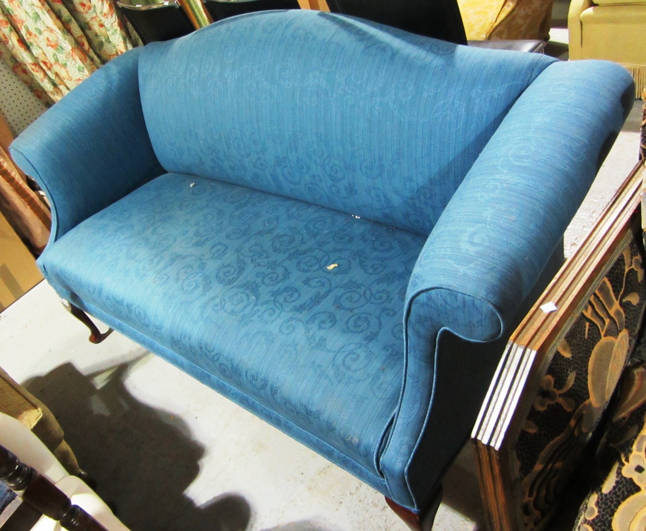 Appraisal: A George II style mahogany framed blue upholstered sofa