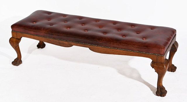 Appraisal: A LEATHER BUTTON UPHOLSTERED RECTANGULAR STOOL on carved claw feet