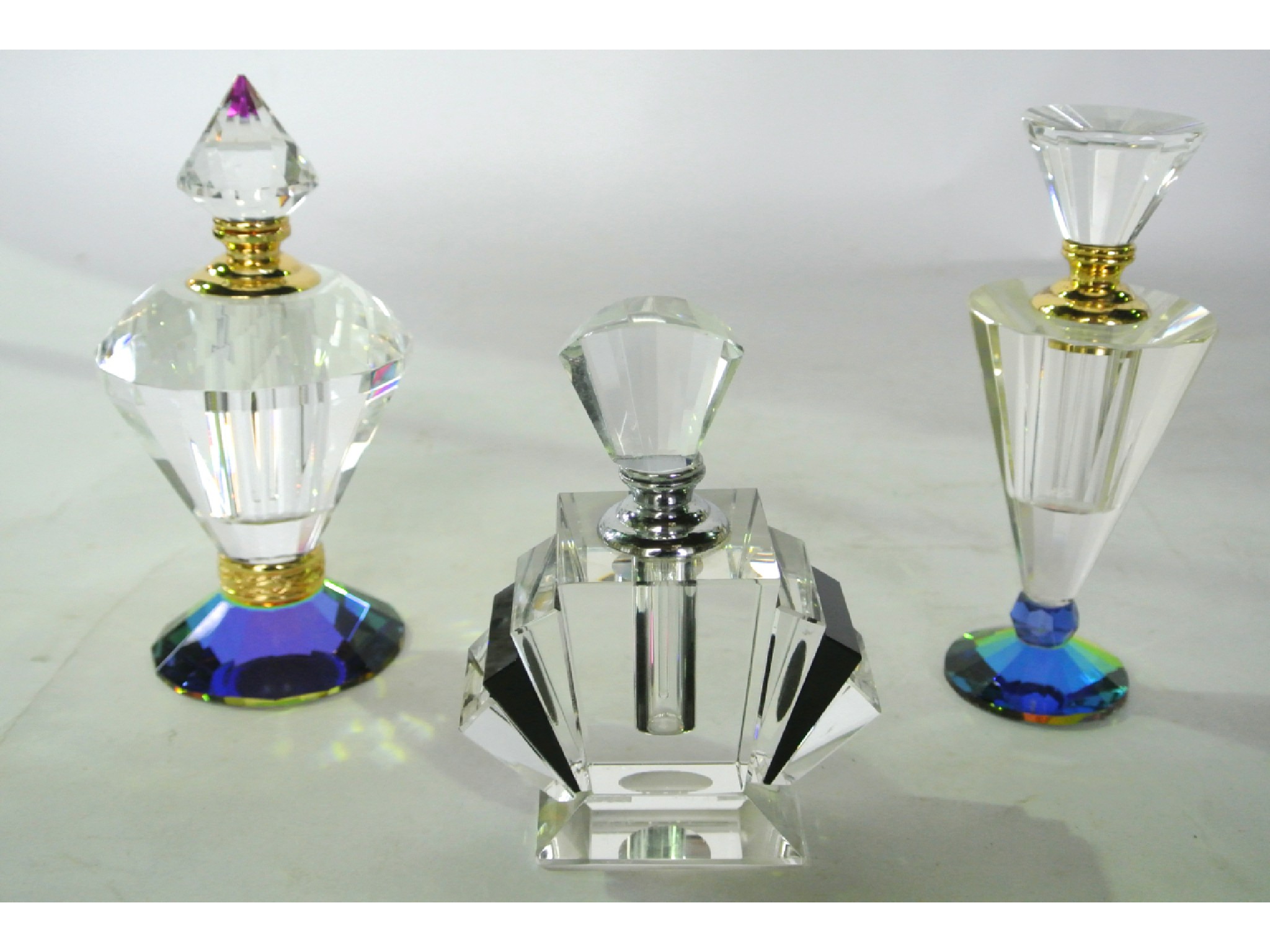 Appraisal: Three good quality art deco style cut glass scent bottles