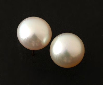 Appraisal: A pair of South Sea pearl earrings The round button