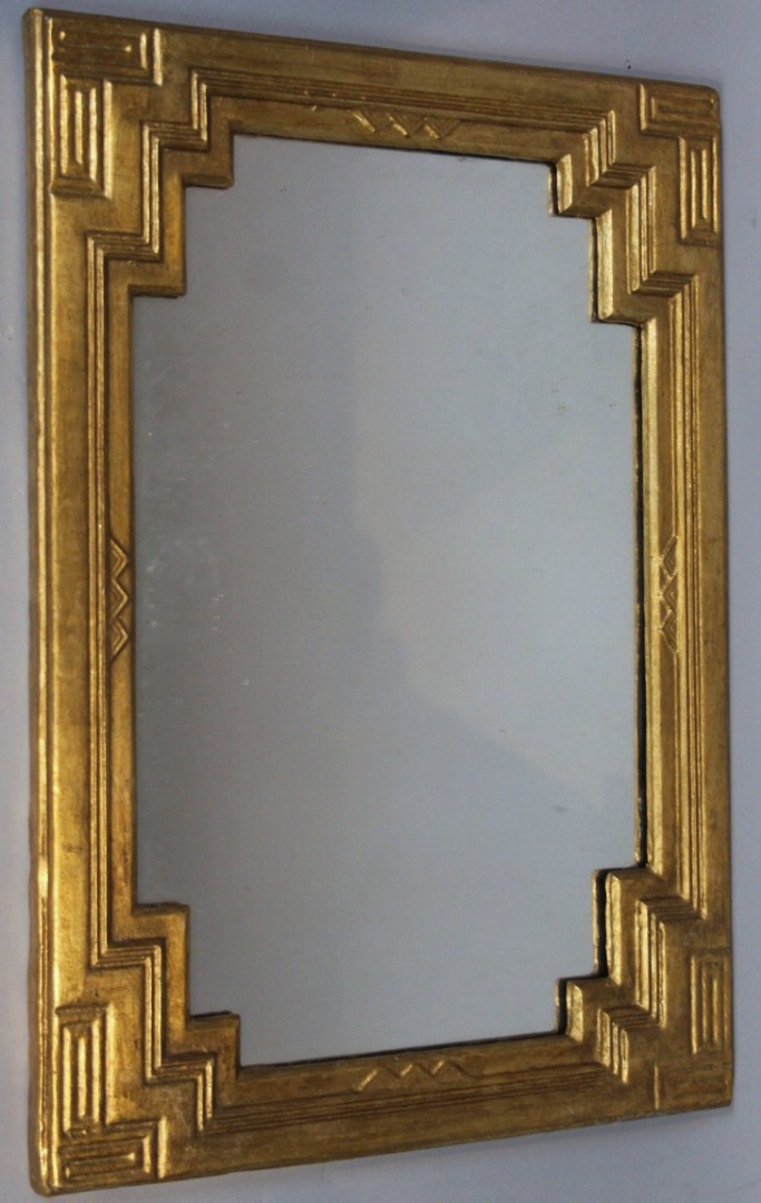 Appraisal: A gilt wood mirror the rectangular outline heavily carved with