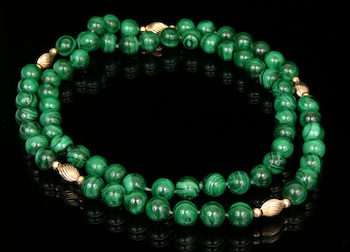 Appraisal: A Strand of Malachite and Gold Beads A long strand