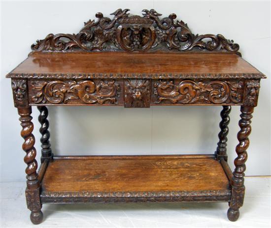 Appraisal: th century oak two tier buffet the carved raised back