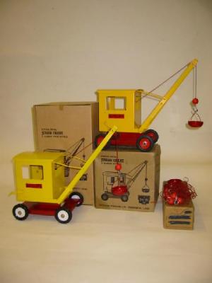 Appraisal: Two push-along Junior Cranes yellow on red base one with