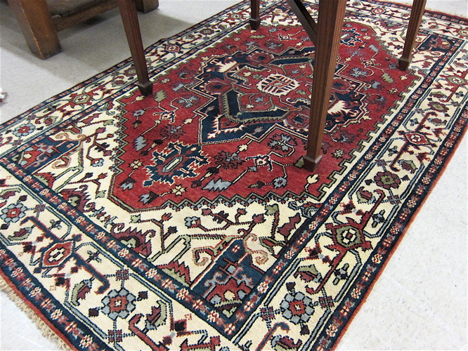 Appraisal: HAND KNOTTED ORIENTAL CARPET Persian Serapi design geometric central medallion