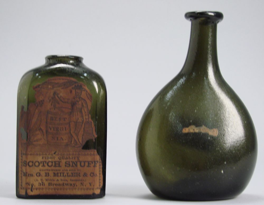 Appraisal: TWO EARLY OLIVE GREEN GLASS BOTTLES Early th CenturyBlown glass