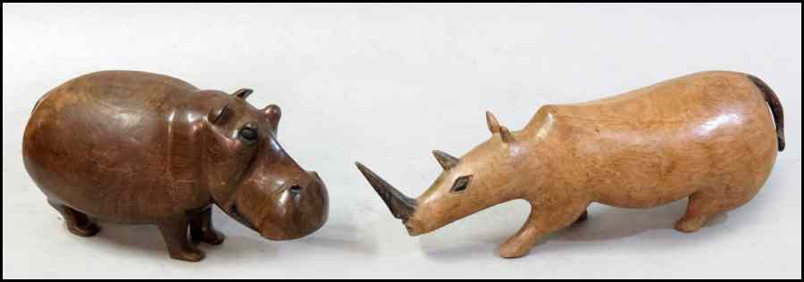 Appraisal: CARVED HARDWOOD RHINOCEROS Together with a carved hardwood hippopotamus Rhinoceros