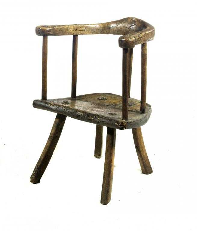 Appraisal: A SCOTTISH PRIMITIVE ASH WINDSOR CHAIR with shaped armbow and