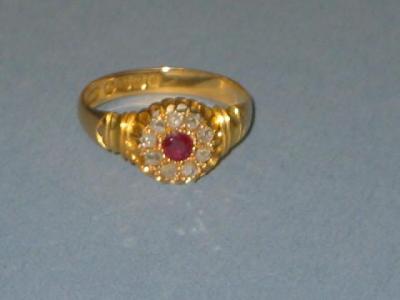 Appraisal: AN EDWARDIAN RUBY AND DIAMOND RING set as a flowerhead