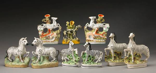 Appraisal: An assembled grouping of nine Staffordshire pottery zebras second half