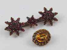 Appraisal: A garnet set bar brooch comprising three star clusters together