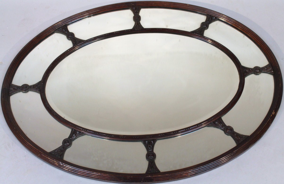 Appraisal: A late thC mahogany framed mirror with an oval moulded