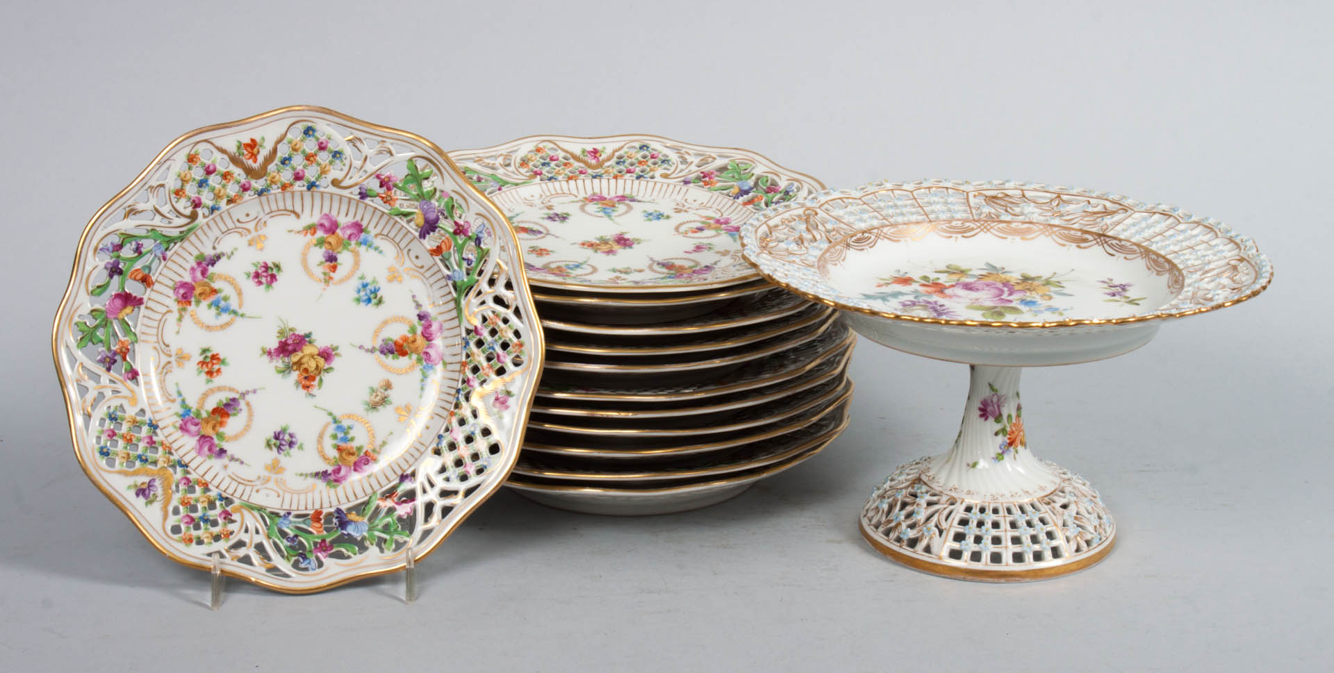 Appraisal: German porcelain reticulated plates and compote early th century Schumann