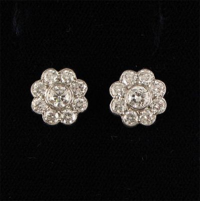 Appraisal: A pair of diamond cluster earstuds The brilliant cut diamonds