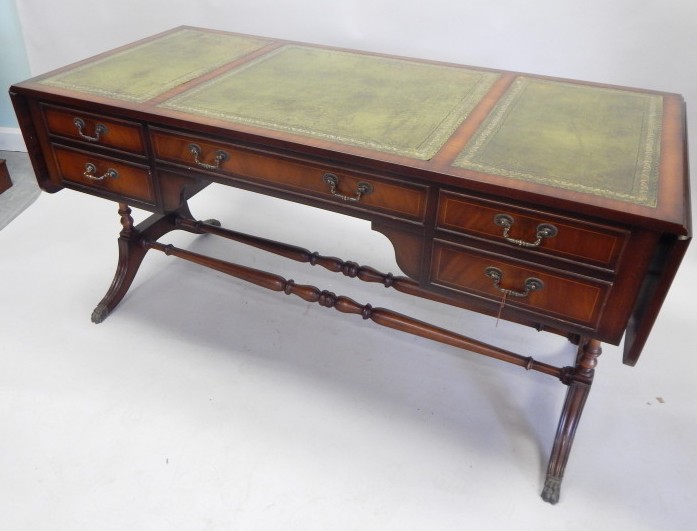 Appraisal: A large reproduction mahogany desk the rectangular top with two