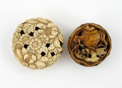 Appraisal: Two Japanese ivory netsukes one a manju netsuke pierced and