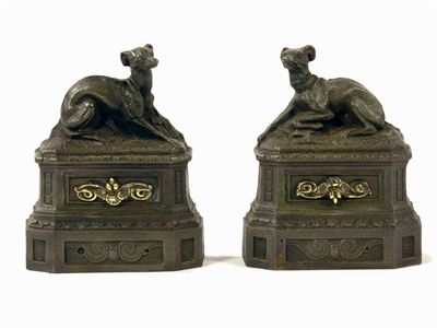 Appraisal: A pair of cast iron fire dogs modelled as seated