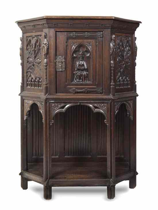 Appraisal: A Renaissance Revival Carved Oak Cabinet of trapezoidal form the