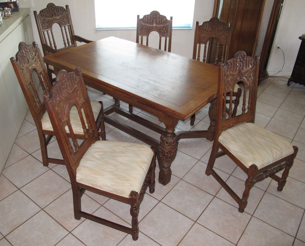 Appraisal: DRAW LEAF CARVED OAK DINING TABLE AND CHAIRS Oak top