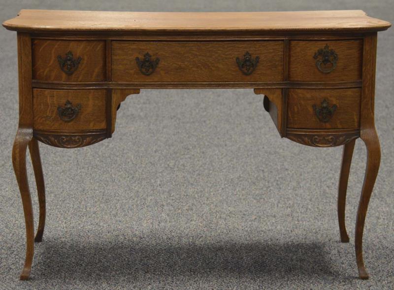 Appraisal: Oak Writing Desk Writing desk with curved drawers and ornate